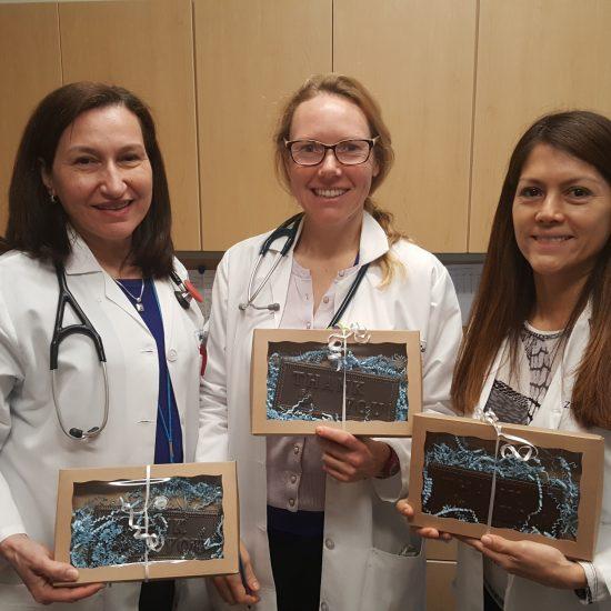 Photo of three Zufall Health medical providers holding small gifts of appreciation