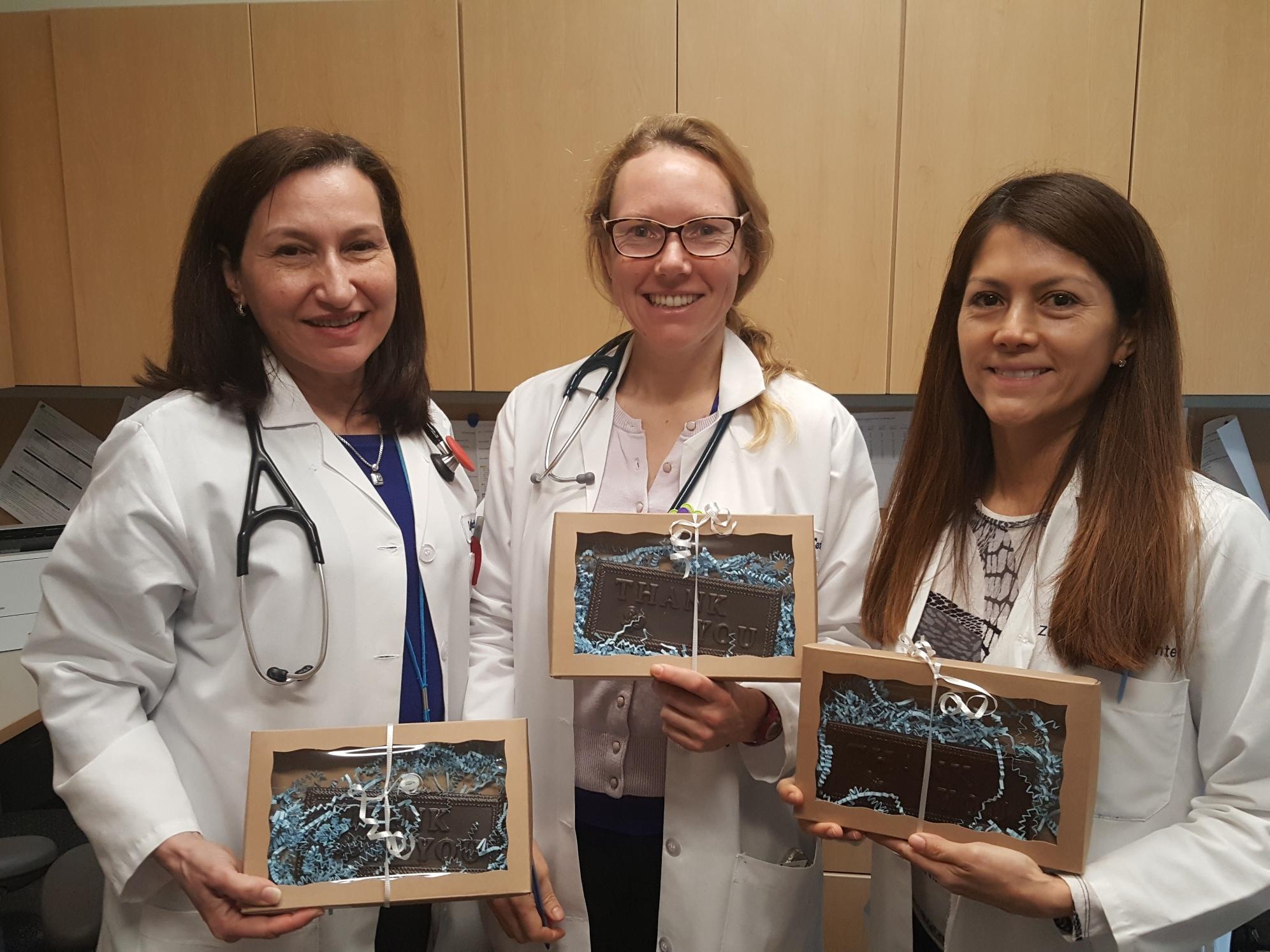 Photo of three Zufall Health medical providers holding small gifts of appreciation