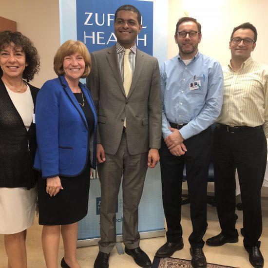 Photo of New Jersey's Health Commissioner posing with Zufall staff and Board