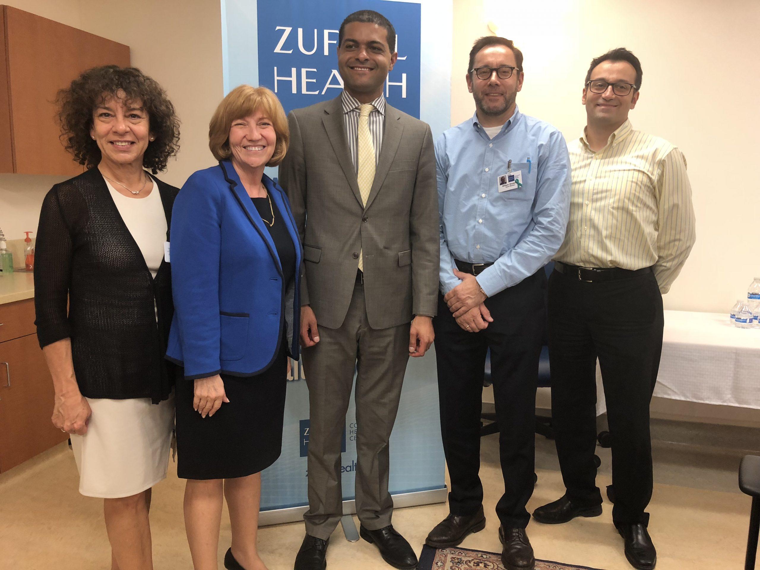 Photo of New Jersey's Health Commissioner posing with Zufall staff and Board