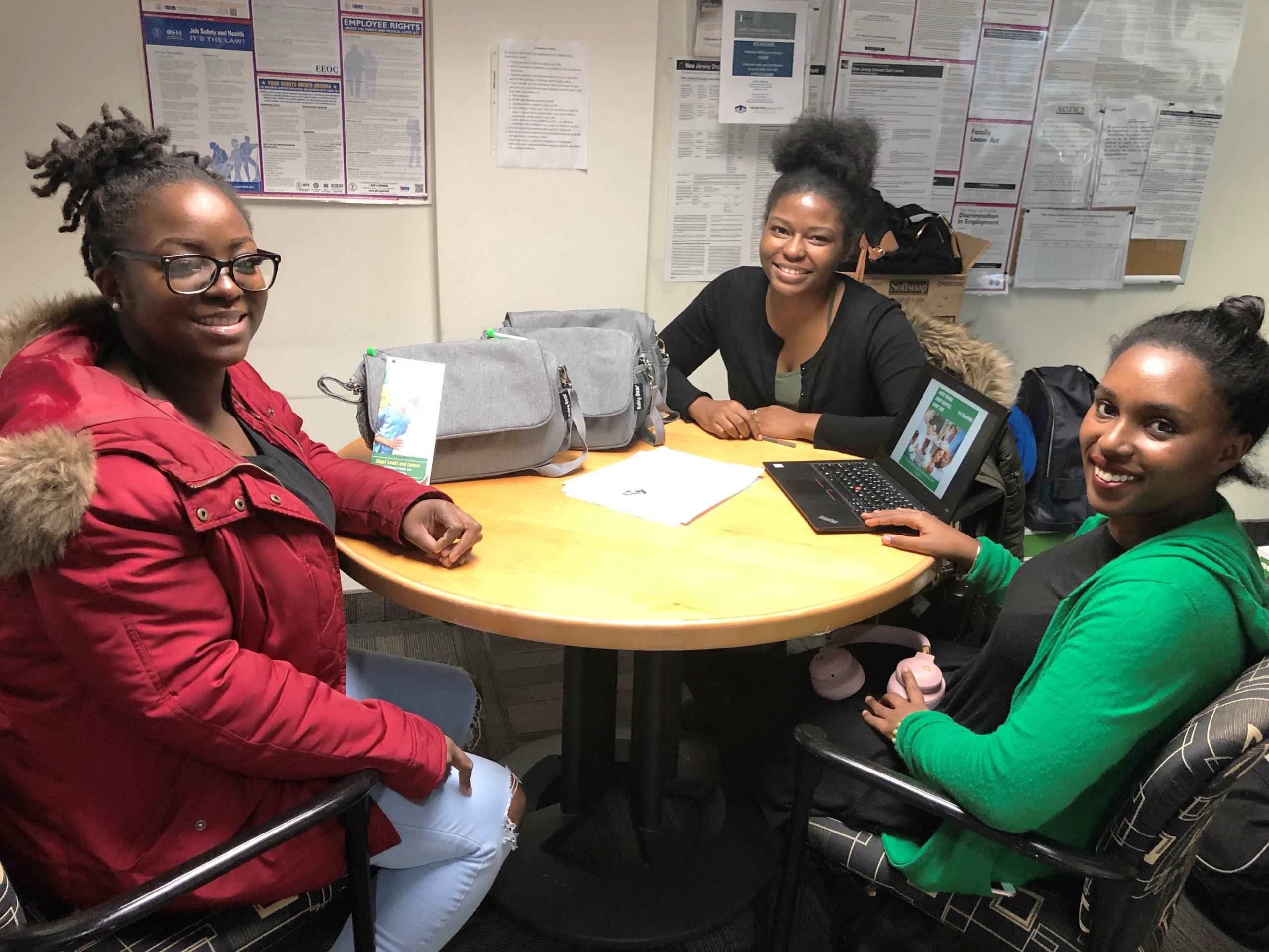 Prenatal patients sitting at a table for Maternal Health Awareness Day event