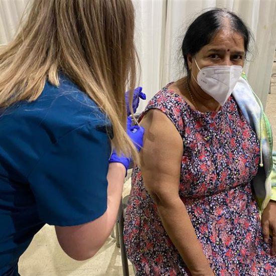 Woman receiving COVID-19 vaccine booster shot