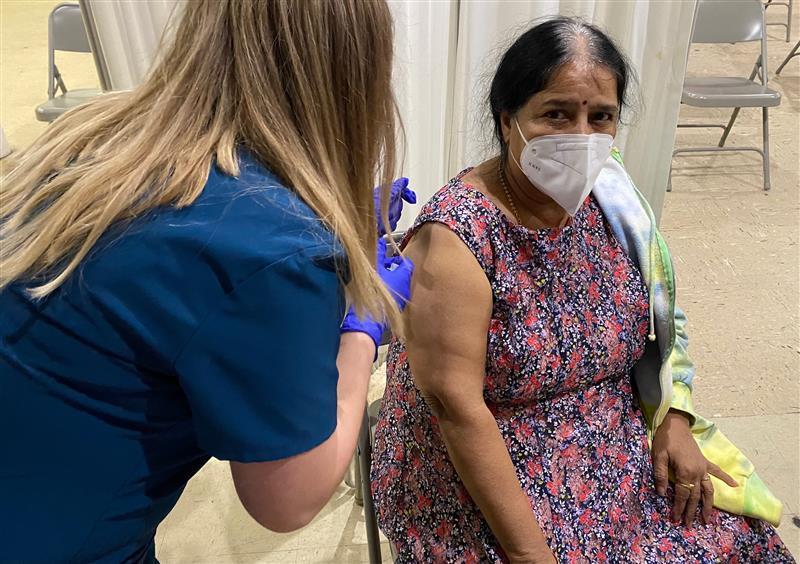 Woman receiving COVID-19 vaccine booster shot