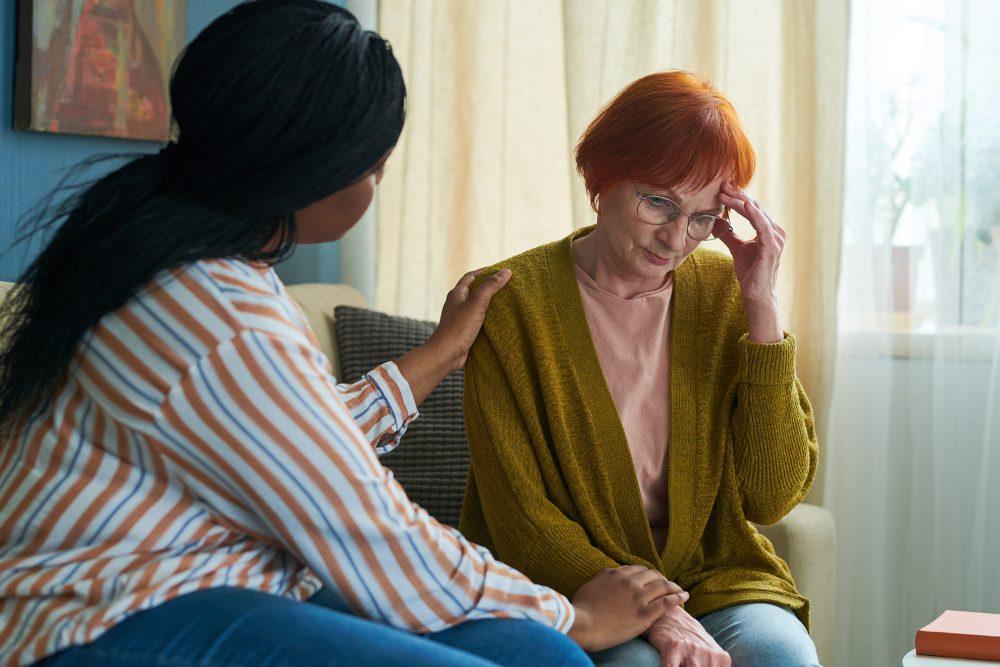 caregiver comforting woman with depression