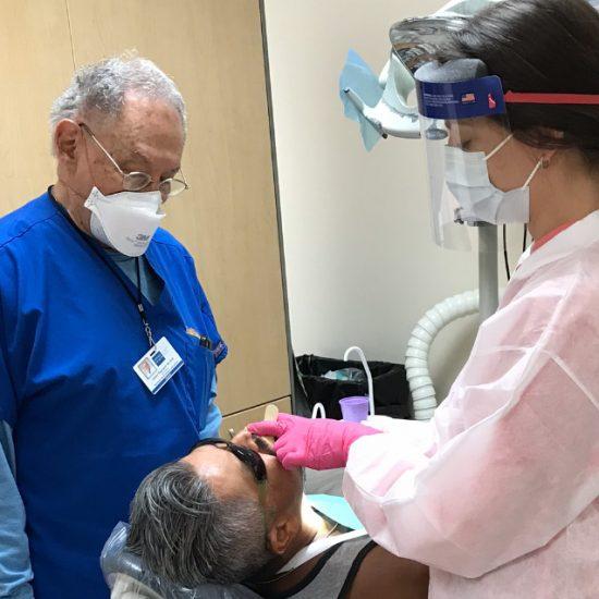 Person observing a dentist and patient