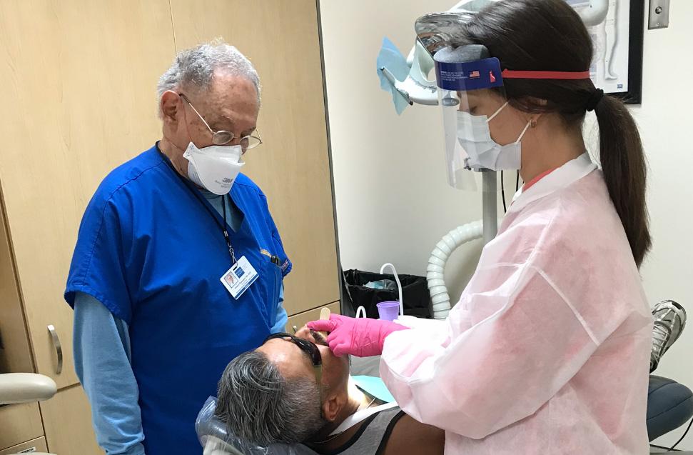 Person observing a dentist and patient